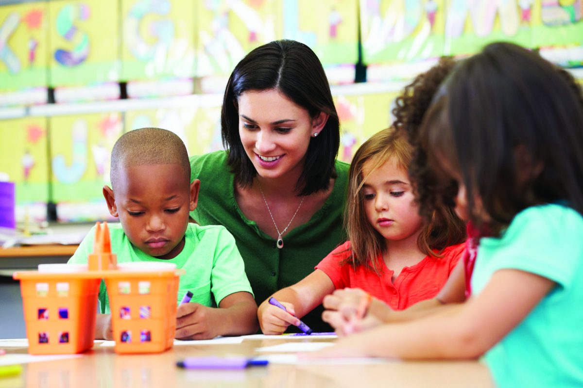Group Of Elementary Age Children In Art Class With Teacher