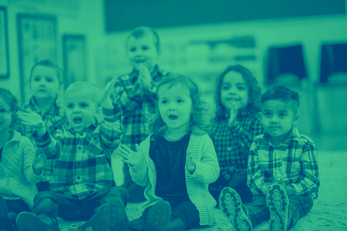 A group of young, early years aged children in a school classroom