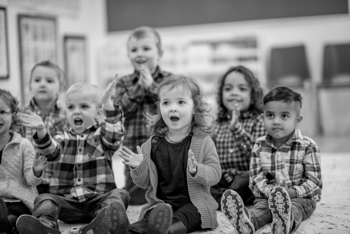 A group of young, early years aged children in a school classroom